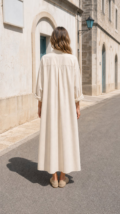 Back view of woman wearing beige maxi shirt dress