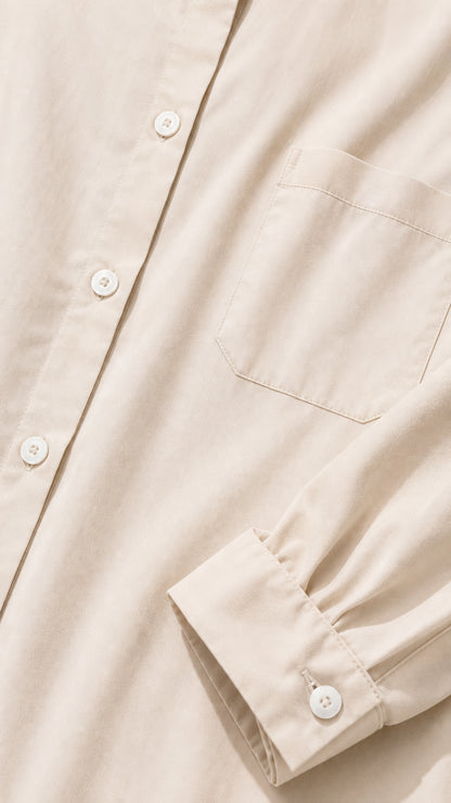 Close-up detail of shirt dress fabric, buttons, collar, and chest pocket