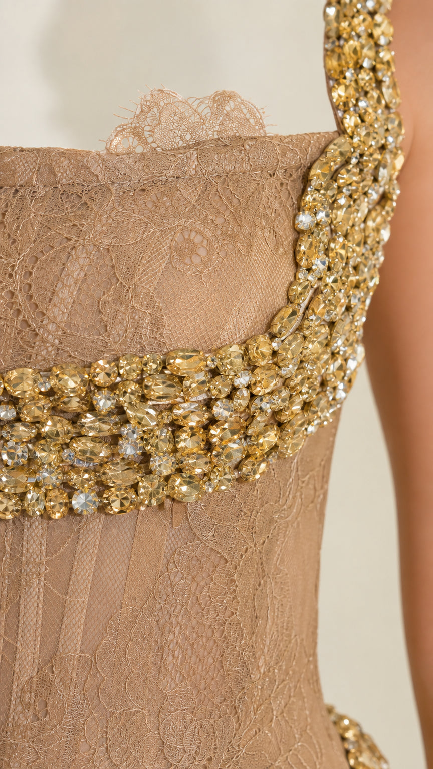 Close-up detail of the rhinestone shoulder strap and lace bodice